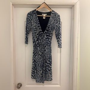 Asymmetrical blue 3/4 sleeve dress. Worn once. Stretchy and flattering.